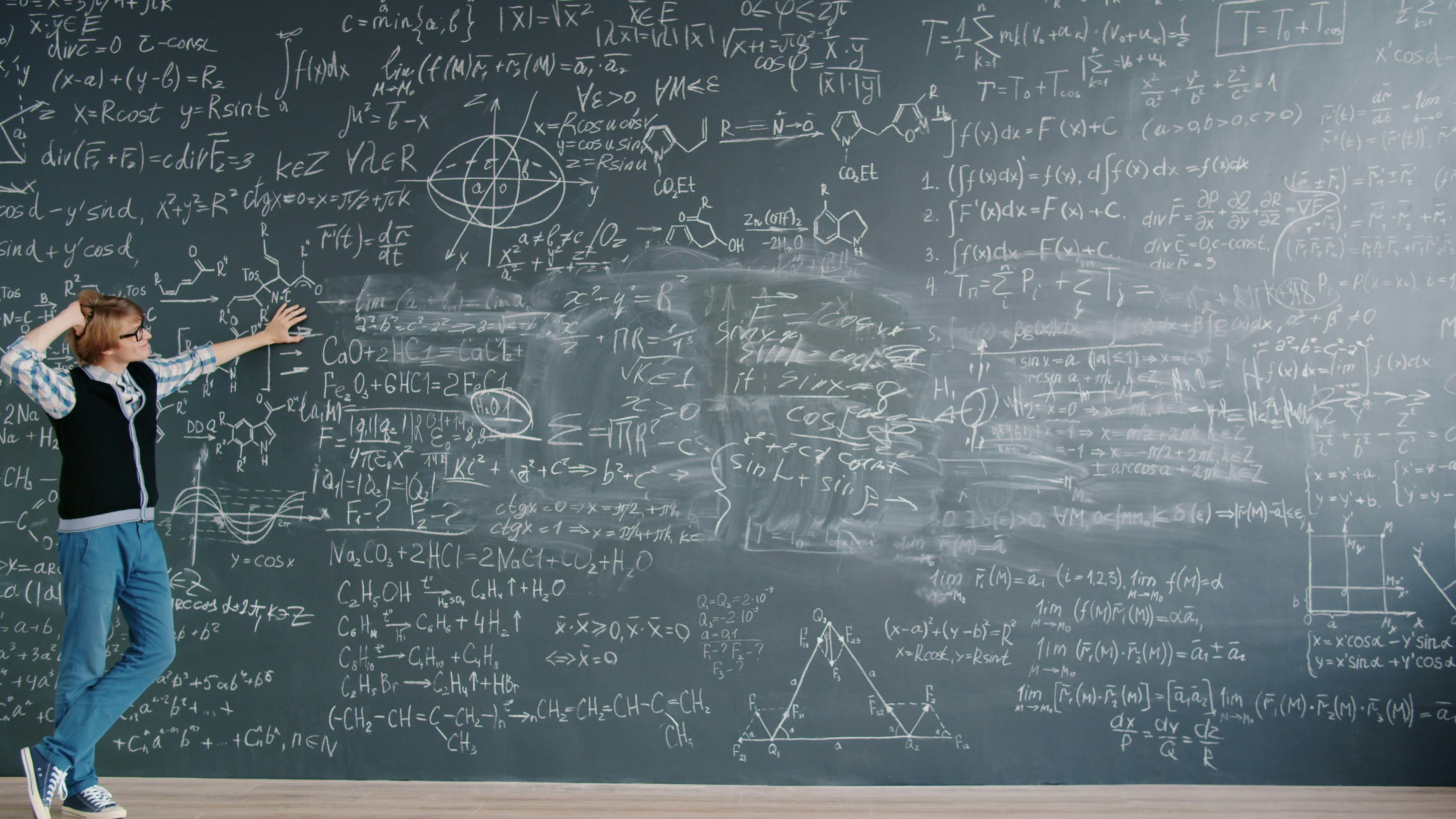Time-lapse of smart young man scientist walking in class looking at chalkboard with formulas thinking about science problem. People and challenges concept.